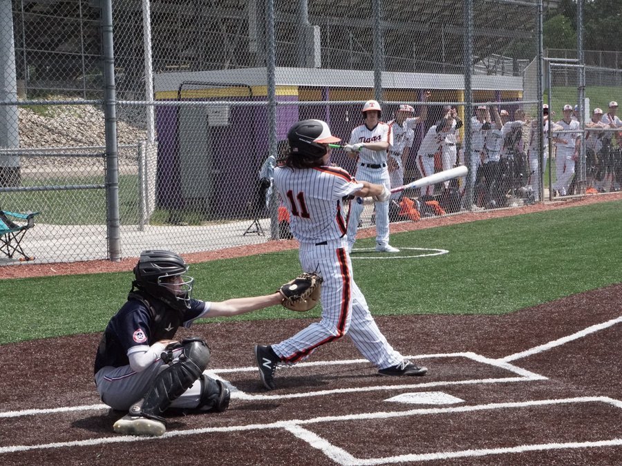 Baseball batter mid-swing at the plate
