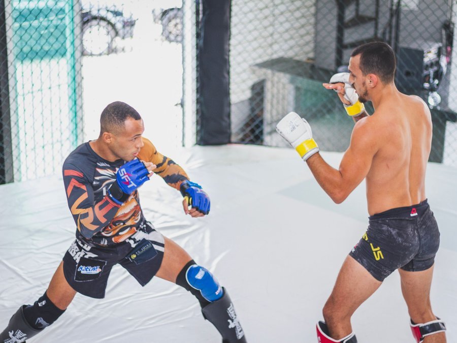 MMA fighters sparring in the cage