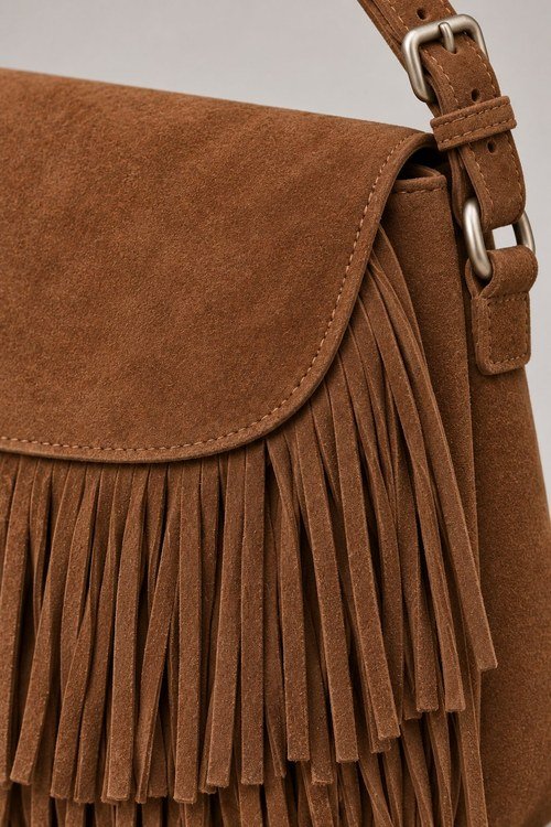 Close-up of the Fringe Crossbody Bag's adjustable strap buckle