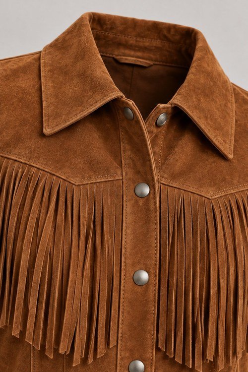 Close-up of the Classic Fringe Suede Jacket's yoke fringe, collar and snap placket